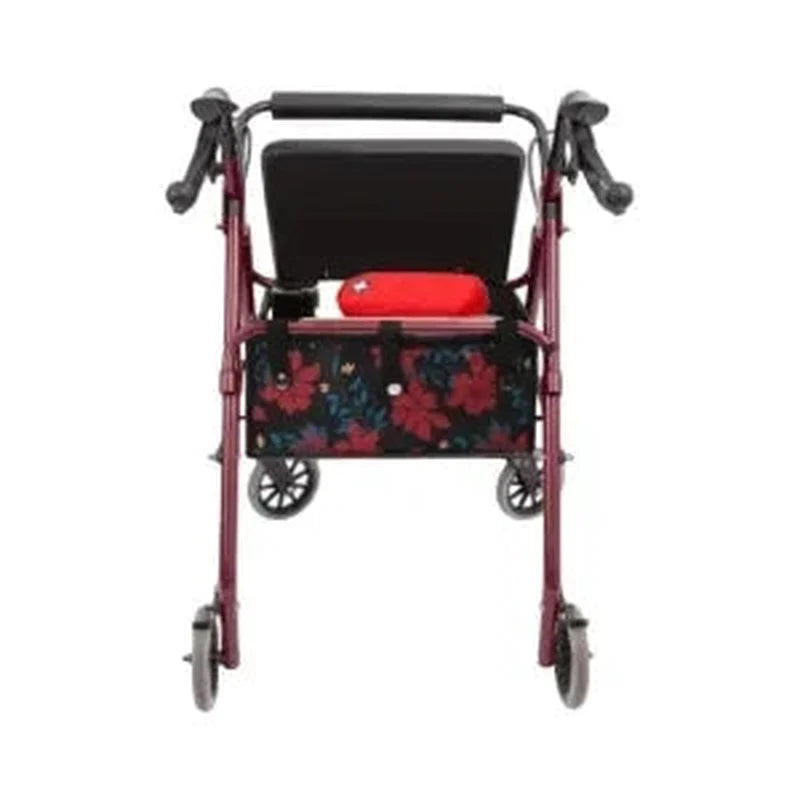 Sort rollator taske med rødt og blåt plantemotiv monteret på mørkerød rollator